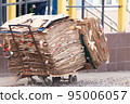 A janitor cart with packed cardboard. 95006057