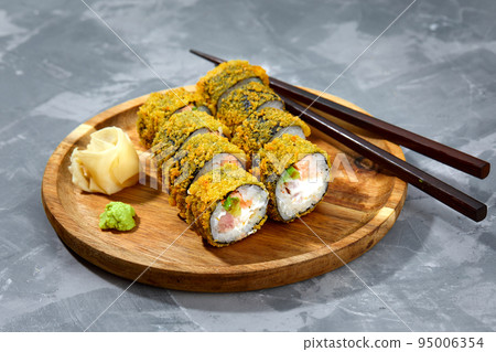 Tempura Maki Sushi Deep Fried Sushi Roll Served on wooden board Tempura Maki Sushi Deep Fried Sushi Roll Served on wooden board 95006354