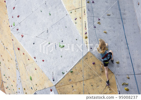 teen girl climbing up the wall 95008237