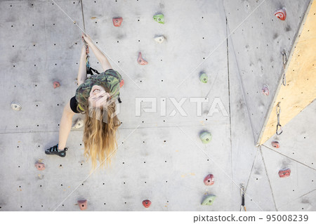 teen girl climbing up the wall 95008239