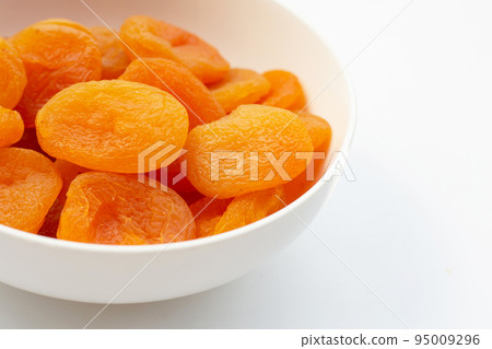 Dried apricots on white background. 95009296