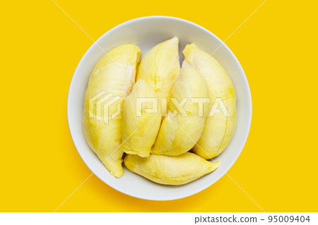 Fresh ripe durian in white plate on yellow background. Fresh ripe durian in white plate on yellow background. 95009404