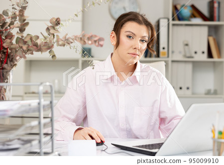Woman accountant sitting at her working table in office 95009910