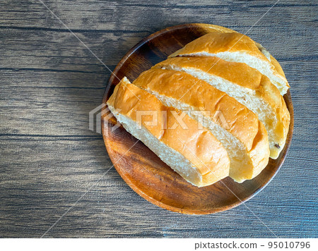 Whole grain bread ready to eat on the wooden background 95010796