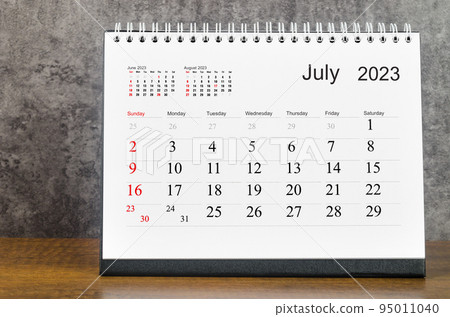 The July 2023 Monthly desk calendar for 2023 year on wooden table. 95011040