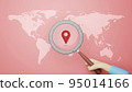 World map with a magnifying glass pointing on red background. 3D illustration 95014166
