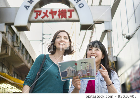 A young woman sightseeing in Tokyo with a foreigner A young woman sightseeing in Tokyo with a foreigner 95016403