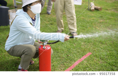 A woman who participated in a fire extinguisher drill at a disaster prevention event (focus on hand) A woman who participated in a fire extinguisher drill at a disaster prevention event (focus on hand) 95017358