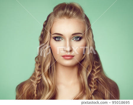 Blonde girl with long and shiny curly hair 95018695
