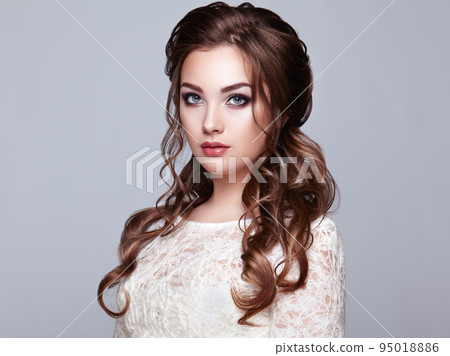 Brunette woman with long and shiny curly hair Brunette woman with long and shiny curly hair 95018886