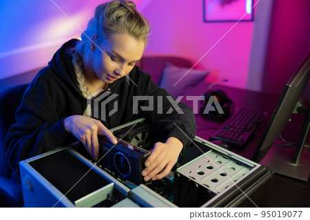 E-sport Gamer Girl Installing New GPU Video Card in Her Gaming PC E-sport Gamer Girl Installing New GPU Video Card in Her Gaming PC 95019077