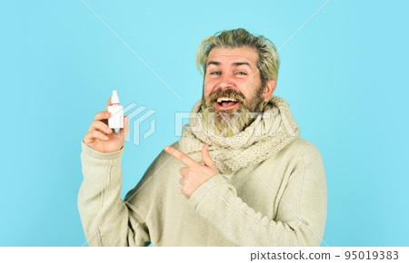 Fast recovery. Cold flu remedies. Runny nose and symptoms of cold. Man scarf hold nasal spray. Medicines effective recovery. Recommended medical treatment. Runny nose recovery. Health care concept 95019383