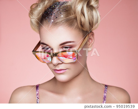 Portrait of beautiful young woman with colored glasses Portrait of beautiful young woman with colored glasses 95019539