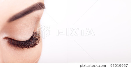 Female eye with long false eyelashes 95019967