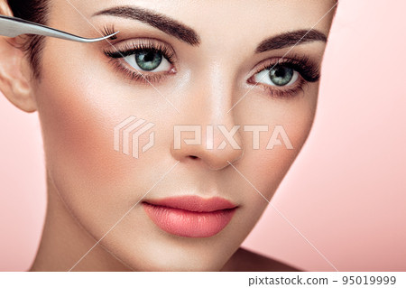 Beautiful woman with long false eyelashes 95019999