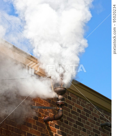 Steam whistle in a brick wall 95020234