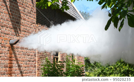 Steam whistle in a brick wall 95020235