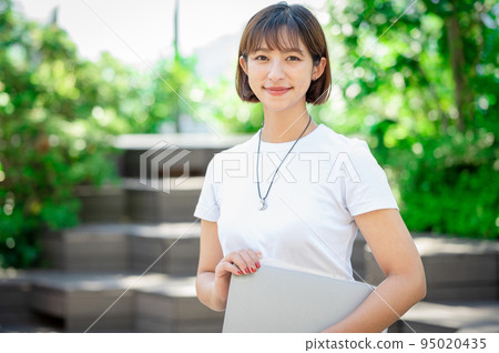 Smiling female portrait, personal computer, casual Smiling female portrait, personal computer, casual 95020435