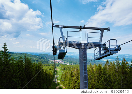 Open cable car line. Metal cable and moving rollers on platform for funicular mechanism, close up. Karpacz resort in Poland with lift road 95020443