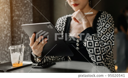 Businesswoman using mobile phone, tablet.Closeup on blurred background. Businesswoman using mobile phone, tablet.Closeup on blurred background. 95020541