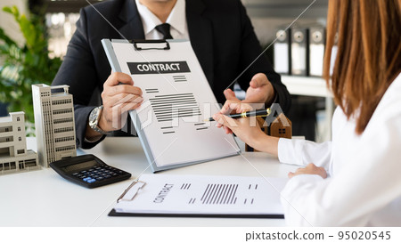 Sales giving male customer signing sales contract, Asian woman and man doing business in office, business concept and contract signing. 95020545