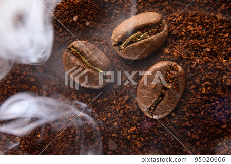 Ground coffee and coffee beans, coffee in light smoke. Ground coffee and coffee beans, coffee in light smoke. 95020606