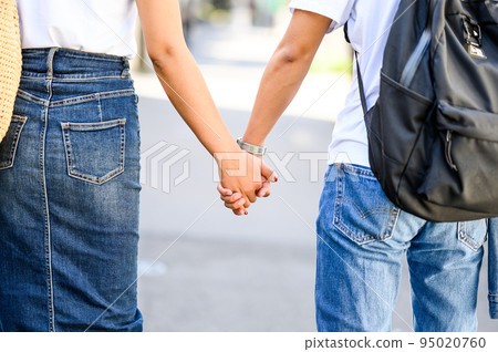 Man and woman holding hands couple love 95020760