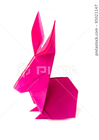 Pink paper rabbit origami isolated on a white background Pink paper rabbit origami isolated on a white background 95021147