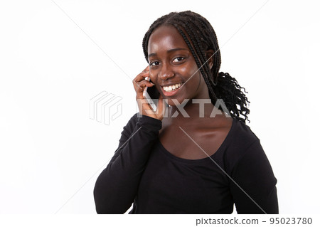 Portrait of cheerful young woman talking on mobile phone Portrait of cheerful young woman talking on mobile phone 95023780