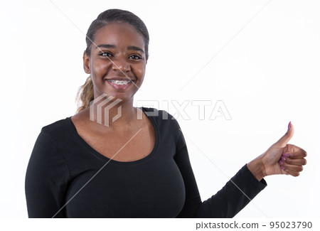 Portrait of cheerful young woman making thumb up 95023790