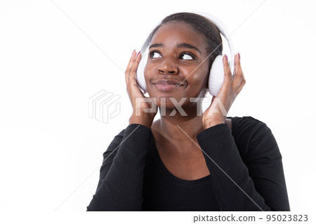 Portrait of happy young woman dancing in headphones Portrait of happy young woman dancing in headphones 95023823