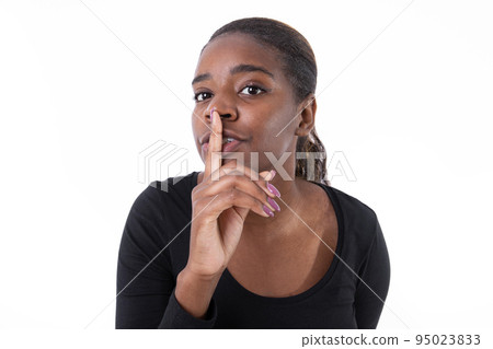 Portrait of cute African American woman shushing Portrait of cute African American woman shushing 95023833