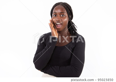 Portrait of excited young woman standing with open mouth 95023850