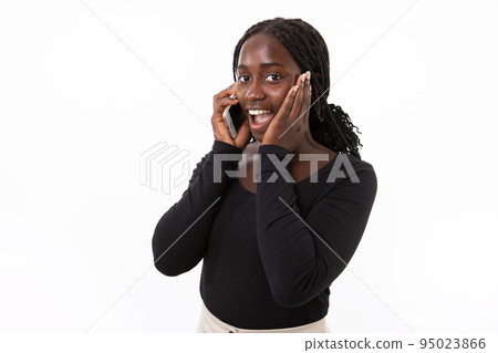 Portrait of amazed young woman talking on mobile phone Portrait of amazed young woman talking on mobile phone 95023866