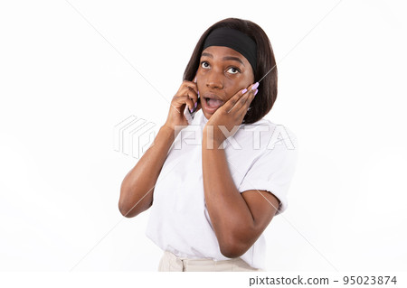 Portrait of excited young woman talking on mobile phone Portrait of excited young woman talking on mobile phone 95023874