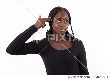 Portrait of smiling young woman making suicide gesture Portrait of smiling young woman making suicide gesture 95023891