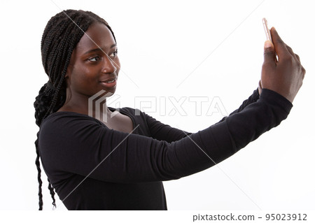 Portrait of happy young woman taking selfie with smartphone Portrait of happy young woman taking selfie with smartphone 95023912