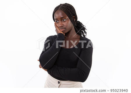 Portrait of pensive young woman leaning head on hand Portrait of pensive young woman leaning head on hand 95023940