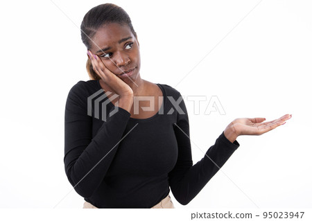 Portrait of tired African American woman pointing with palm 95023947