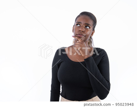 Portrait of doubtful young woman looking away Portrait of doubtful young woman looking away 95023948