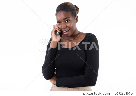 Portrait of positive young woman talking on mobile phone Portrait of positive young woman talking on mobile phone 95023949