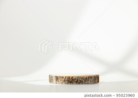 Wood slice podium with window shadow on white background for cosmetic product mockup 95023960