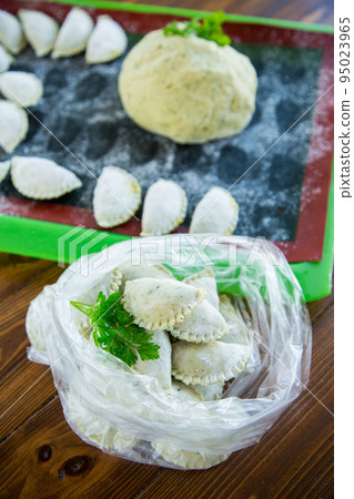 Raw green dough dumplings with parsley, dill. Raw green dough dumplings with parsley, dill. 95023965