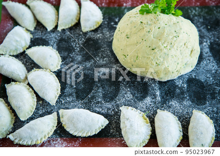 Raw green dough with parsley, dill with raw dumplings. Raw green dough with parsley, dill with raw dumplings. 95023967