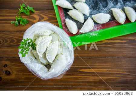 Raw green dough dumplings with parsley, dill. 95023968