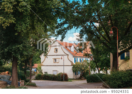 Traditional small house with beautiful outdoor decor facade in Germany. German old brick building house ancient European city German architect 95024331