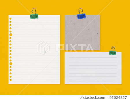 Empty note paper with clip on yellow art paper background. 95024827