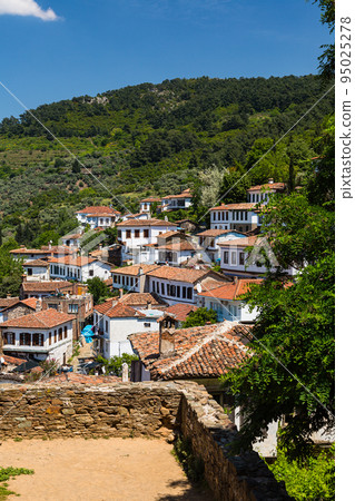 Townscape spreads out on the mountain slopes of Sirince, Turkey 95025278