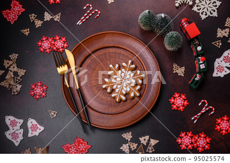 Christmas decoration elements as well as gingerbread on a brown concrete background Christmas decoration elements as well as gingerbread on a brown concrete background 95025574