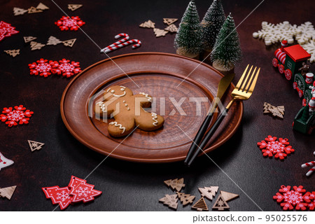 Christmas decoration elements as well as gingerbread on a brown concrete background Christmas decoration elements as well as gingerbread on a brown concrete background 95025576